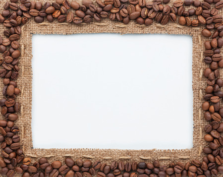 Frame of burlap and coffee beans, lying on a white backgroundの写真素材