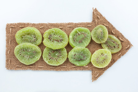 Pointer of  burlap with dried kiwi, on a white backgroundの写真素材