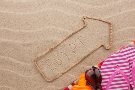 Egypt  pointer and beach accessories lying on the sand, as backgroundの写真素材