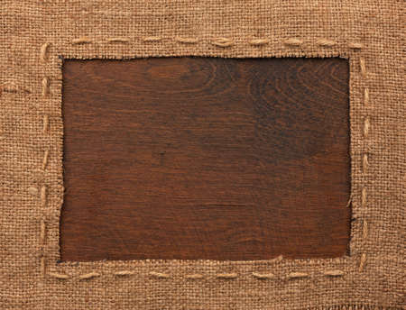 Frame of burlap, lies on a background of wood, with place for your textの写真素材