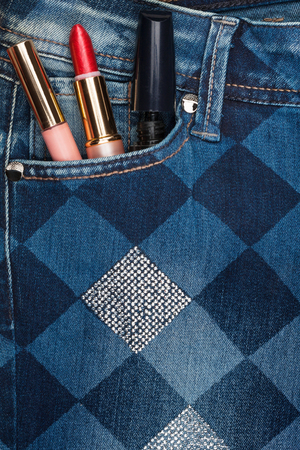 Cosmetics sticks out of the pocket of jeans with rhinestonesの写真素材