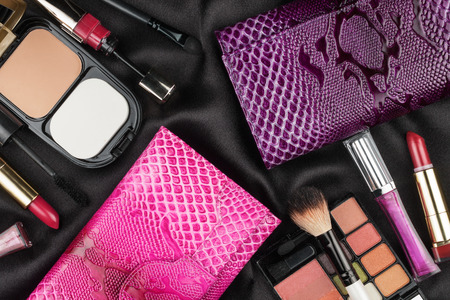 Beautiful pink and lilac bags among cosmetics, as backgroundの写真素材