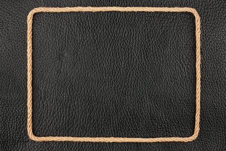 Frame of rope, lies on a background of a black natural leather, with place for your textの写真素材