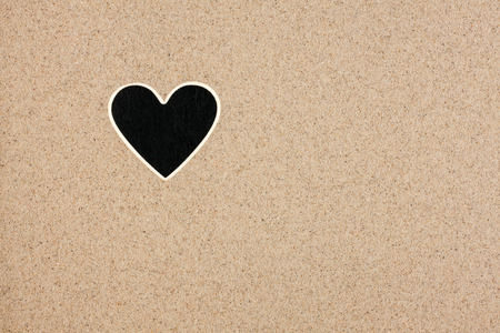 Pointer, ads board in the form heart  in the sand, can be used as backgroundの写真素材