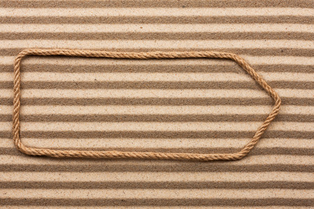 Pointer made of rope on the sand, with place for your textの写真素材