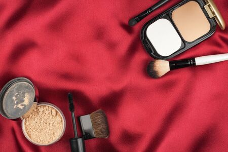 Beautiful picture of cosmetic  on red silk, with space for your textの写真素材