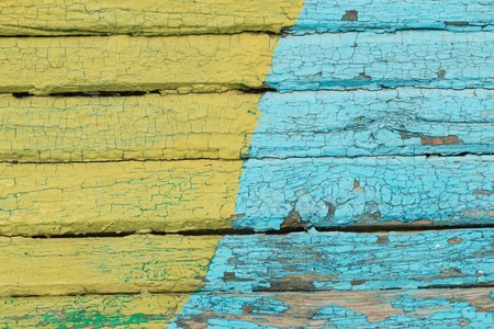 Vintage wood background with peeling  yellow and blue paint.textureの写真素材