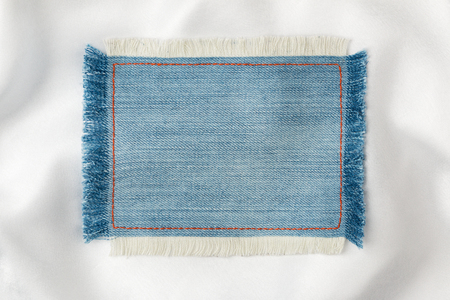 Frame made of denim fabric with yellow stitching on white silk, with space for your text