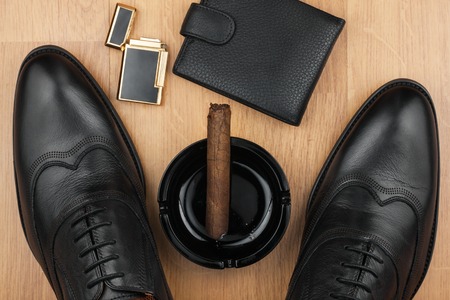 Male still life, classic men's shoes and a cigar in an ashtray, can use as backgroundの写真素材