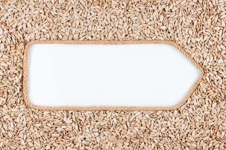 Pointer made from rope with seeds sunflower  lying on a white background, with space for your textの写真素材