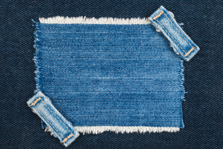 Frame with two straps jeans, lies on the dark denim, with space for your textの写真素材