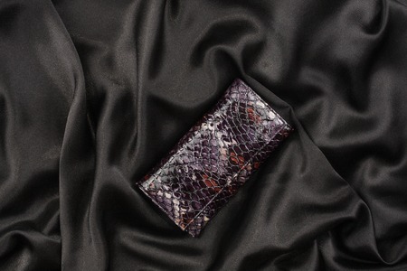 Purse lacquer on a black silk, as backgroundの写真素材