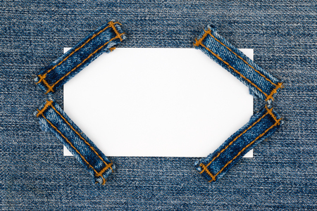 Business card with four straps jeans, lies on the light denim, with space for your textの写真素材