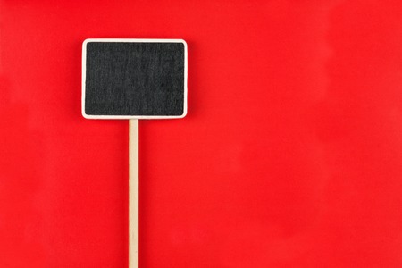 Pointer with space for your text, lies on red  backgroundの写真素材