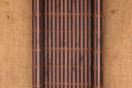 Bamboo mat in the form of a manuscript on sackcloth, top viewの写真素材