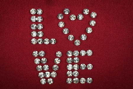 Word LOVE laid out rhinestones, can be used as backgroundの写真素材