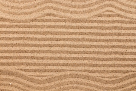 Frame made of zigzag on wavy sand. Texture sand. View from aboveの写真素材
