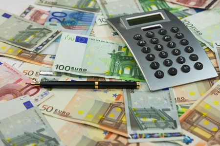 Calculator and money lie on the background of euros. Ideas and concepts of business. Close-upの写真素材