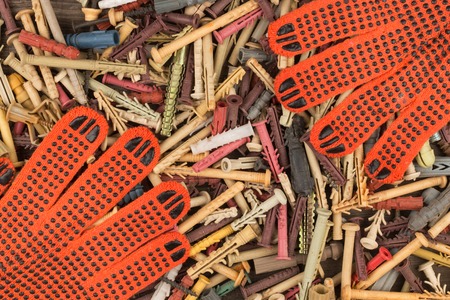 Work gloves lie on a heap of dowels.. Space for text. View from above