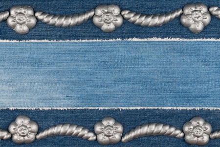 Luxury elegant frame made of silver stucco plaster lying on denim. Copy space. View from aboveの写真素材