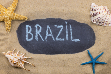 Handwritten word BRAZIL written in chalk, among seashells and starfishes. Top viewの写真素材