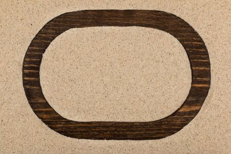 Wooden blank frame with on beach sand. Top view. Copy spaceの写真素材