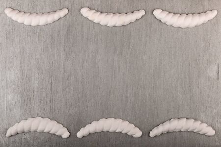 Gypsum cornice, stucco, moldings, friezes on a silver background, copy space. Top view