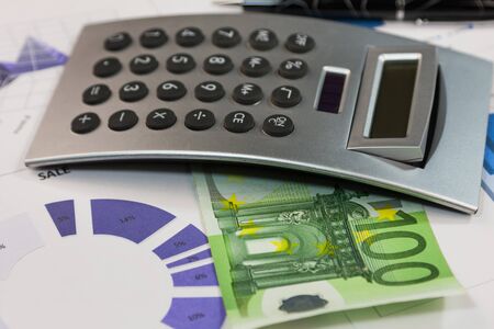 Financial statements. Calculator, euros on financial charts. Close-up. Business conceptの写真素材