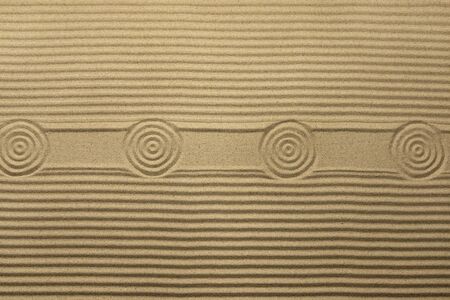 Circles and lines on the sand, with space for design, text place. Texture of sand. View from above