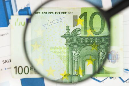 Close-up of hundred euros through a magnifying glass. Business background. Money research concept. Top viewの写真素材