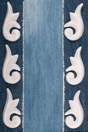 Frame of plaster decorative stucco molding on a denim background. Top viewの写真素材