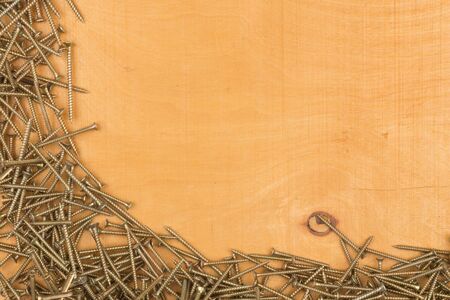 Tapping screws made of steel, metal screw, iron screw, chrome screw. Screws in the frame shape on a...