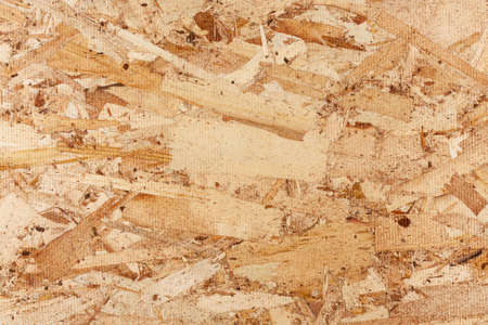 Wood texture. Osb wood board for background decoration. OSB board texture. Brown wooden background. Simple pressed chipboard pattern.の写真素材