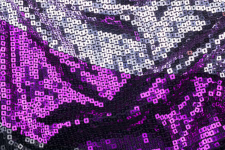 Texture of the surface of the fabric made of sequins. Fashion fabric glitter, sequins. beautiful shiny texture background. Fashionable shiny fabrics for clothing and decoration.の写真素材