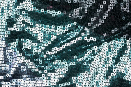 Texture of the surface of the fabric made of sequins. Fashion fabric glitter, sequins. beautiful shiny texture background. Fashionable shiny fabrics for clothing and decoration.の写真素材