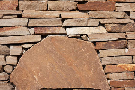 Stone wall texture, background, natural color. Fragment of a wall from a chipped stone. Stone wall texture backgroundの写真素材