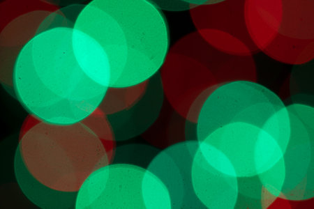 Festive multicolored bokeh background. Abstract blurred colored lights. Black backgroundの写真素材