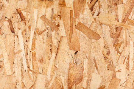 Wood texture. Osb wood board for background decoration. OSB board texture. Brown wooden background. Simple pressed chipboard pattern.の写真素材