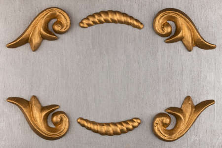 Gold stucco molding on an empty silver background. With space for design, text place. Top viewの写真素材