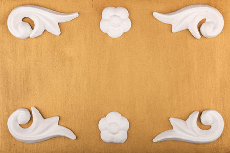 White stucco molding on an empty golden background. With space for design, text place. Top viewの写真素材