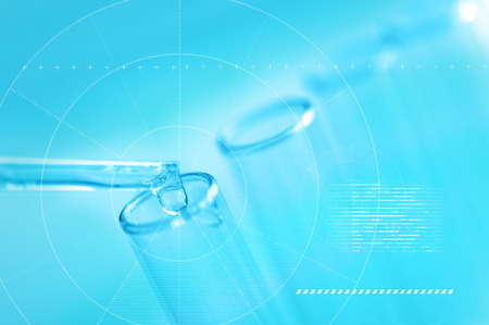 A pipette dropping sample into a test tube,abstract science backgroundの写真素材