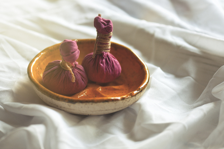 Ayurveda massage powder pads - Kizhi. Body care. Spa body massage treatment.の写真素材