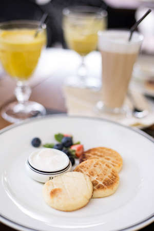 Delicious cottage cheese pancakes or syrniki with fresh blueberry