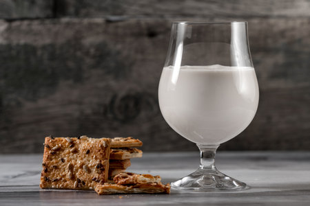 Tasty cookies and glass of yogurt milk on rustic wooden backgroundの写真素材