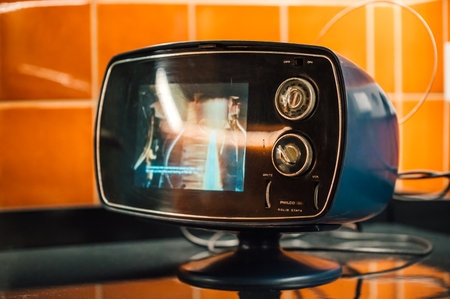 Closeup of a modern black and blue TV set in the kitchenの写真素材