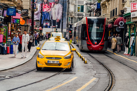 Yellow tram and people on the street in Bangkok.の写真素材
