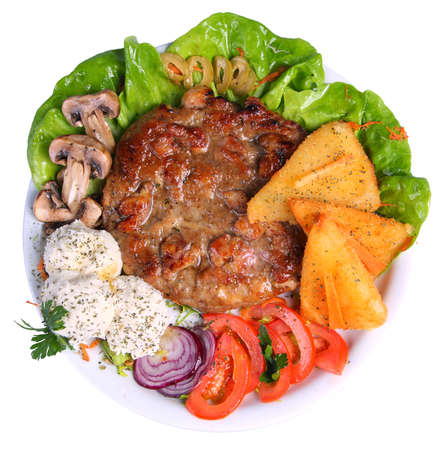 Hamburger on a platter with cheese, tomatoes, mushrooms, onions and lettuce, top angleの写真素材