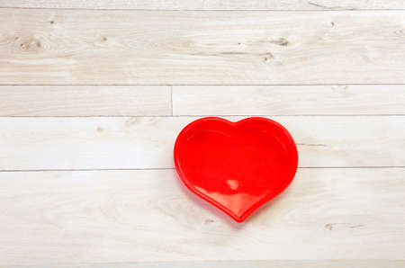 Red hart frame on a wooden backgroundの写真素材