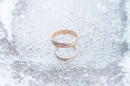 wedding rings closeup on the ice background.の写真素材