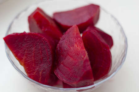 Boiled beets cut into pieces in a plate closeup.の写真素材